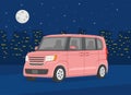 Isolated modern new kei car on the background of the night city. Pink car. Night city with lights. Royalty Free Stock Photo