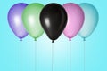 Isolated multicolored balloons of different colors with strings fly up near the light blue background, for holiday,