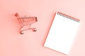 Isolated notepad with mini shopping carts.