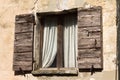 Isolated old window with wooden shutters and white curtains Fiorenzuola di Focara, Italy, Europe Royalty Free Stock Photo