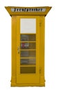 An isolated old yellow public telephone booth Royalty Free Stock Photo