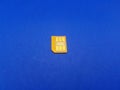 Isolated old yellow sim card with golden chip Royalty Free Stock Photo