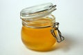 Isolated open glass jar of honey on a white background. Close-up Royalty Free Stock Photo