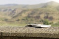 Isolated open notebook with back pen on top of it leaning on the floor with beautiful landscape views in the background Royalty Free Stock Photo