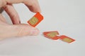Isolated photo of male hand holding red SIM card