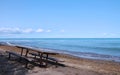 Isolated Picnic table on the Beautiful Beach of Huron Lake Royalty Free Stock Photo