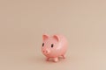 A isolated picture of a piggy bank on a pinkish cream backgroun