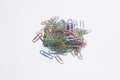 Isolated pile of plastic coated & metal paper clips anodised in colours