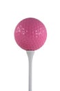 Isolated pink golf ball on a white tee Royalty Free Stock Photo