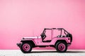 Isolated pink jeep infront of wall, texture, HD background, abstract art.
