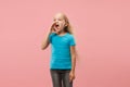 Isolated on pink young casual teen girl shouting at studio Royalty Free Stock Photo