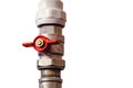 Isolated plumbing valve with red faucet on the plastic water pipe of plumbing system. Close-up Royalty Free Stock Photo