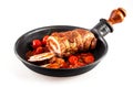 Isolated pork roast and tomatoes in pan Royalty Free Stock Photo