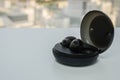 Portable wireless earphone with round black trendy case for music listen