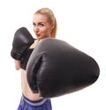 Isolated portrait of athletic Asian woman in black boxing gloves. Slim athletic girl in training clothes looking at Royalty Free Stock Photo