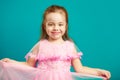 Baby girl in beautiful pink dress on blue isolated Royalty Free Stock Photo