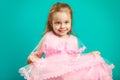 Baby girl in beautiful pink dress on blue isolated Royalty Free Stock Photo