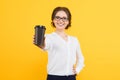 Isolated portrait of confident beautiful young smiling happy business woman offering cup of coffee on yellow background Royalty Free Stock Photo