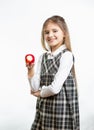 Isolated portrait of happy girl in school uniform holding apple Royalty Free Stock Photo