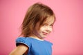 Isolated portrait of little girl with a cunning look.