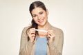 Isolated portrait of smiling young woman holding pregnant test.