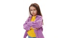 Naughty mischievous little girl pouting lips in resentment, looking at camera with displeased look and her arms folded Royalty Free Stock Photo