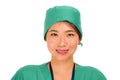 Isolated portrait of young beautiful and happy Asian Korean medicine doctor woman or hospital nurse in medical hat and scrub Royalty Free Stock Photo