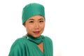 Isolated portrait of young beautiful and happy Asian Korean medicine doctor woman or hospital nurse in medical hat and scrub Royalty Free Stock Photo