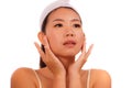 Young beautiful and happy Asian Korean woman applying skincare wrinkle prevention treatment or aging beauty product on her face in