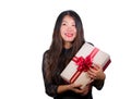 Isolated portrait of young happy and excited beautiful Asian Chinese woman receiving a romantic anniversary gift box holding the Royalty Free Stock Photo