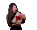 Isolated portrait of young happy and excited beautiful Asian Korean woman receiving a romantic anniversary gift box holding the r Royalty Free Stock Photo