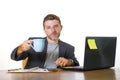 Isolated portrait of young successful and attractive businessman working at office computer desk satisfied and relaxed in