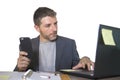 Isolated portrait of young successful and attractive businessman working at office computer desk satisfied and relaxed in