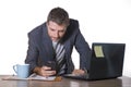 Isolated portrait of young successful and attractive businessman working at office computer desk satisfied and relaxed in