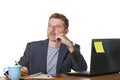 Isolated portrait of young successful and attractive businessman working at office computer desk satisfied and relaxed in