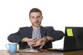 Isolated portrait of young successful and attractive businessman working at office computer desk satisfied and relaxed in