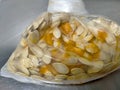 The isolated pumpkin seeds are displaying on the silver stainless table surface texture