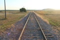 Isolated railway line with straight railway tracks leading into the distance
