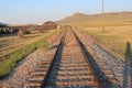 Isolated railway line with straight railway tracks leading into the distance