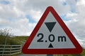 Isolated red, black and white warning triangle in UK for two metre height restriction