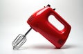 Isolated red electric mixer on white. It is a kitchen appliance for baking and cooking. Handheld mixer tool with beaters is for Royalty Free Stock Photo