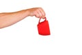 Isolated red mug for coffee, tea in a man& x27;s hand. On a white background Royalty Free Stock Photo