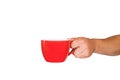 Isolated red mug for coffee, tea in a man& x27;s hand. On a white background Royalty Free Stock Photo