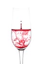 isolated of red water drop to wine glass is still on white background Royalty Free Stock Photo