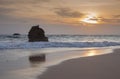 isolated rock with reflection at beautiful sunset, dramatic scenery