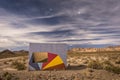 Isolated room with a wall painted with colours in a lonely desertic landscape