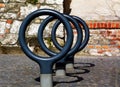 isolated circular steel pipe bicycle racks. urban setting in diminishing perspective. Royalty Free Stock Photo