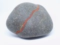 Isolated rounded stone with mineral veins. Stone brown