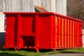 Isolated rugged red industrial dumpster yard