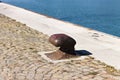 Isolated rusted mooring bollard on the jetty of a commercial dock Italy, Europe